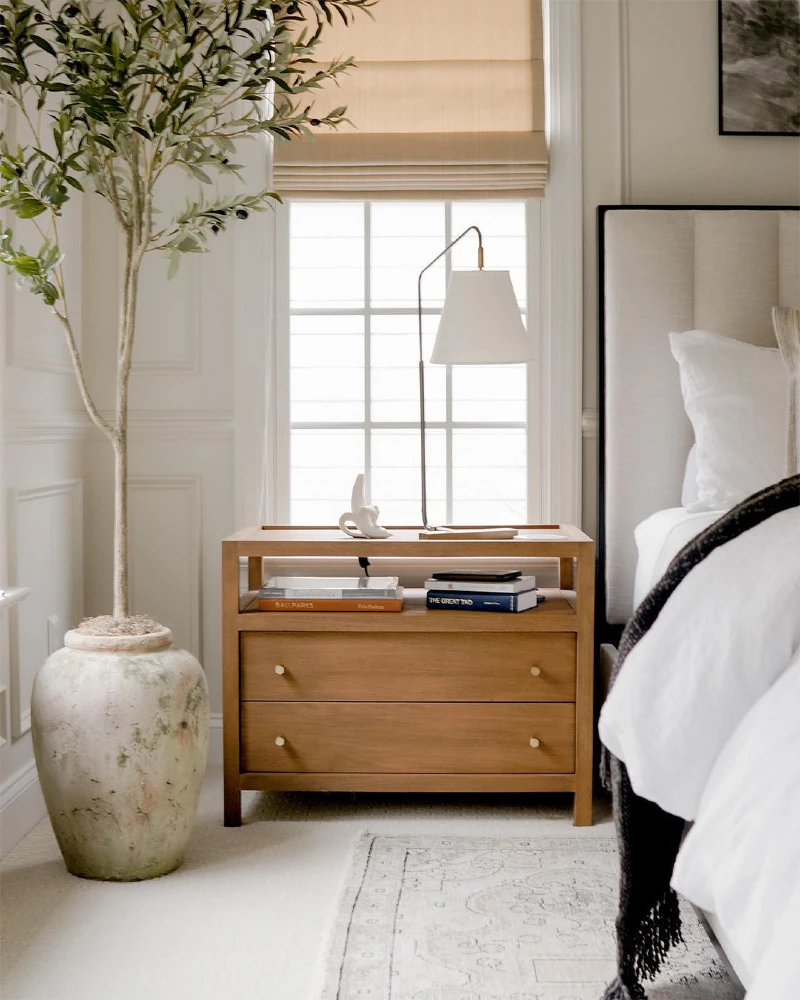 Warm Oak Open-Shelf Nightstand with Slender Task Lamp and Tall Potted Olive Tree