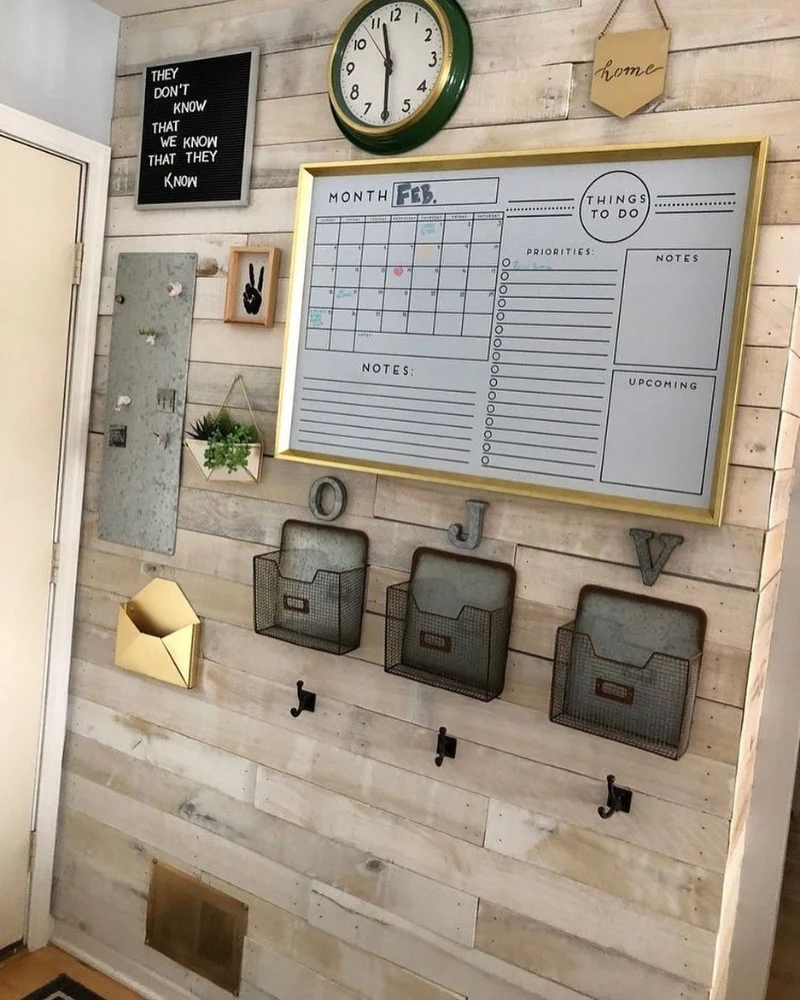 Weathered Wood Shiplap Accent Wall with Brass Framed Planner and Galvanized Baskets