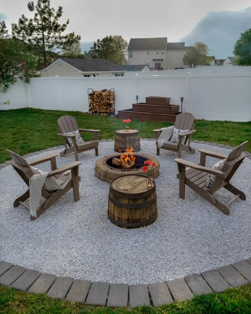  White Gravel Fire Pit Circle with Barrel Tables and Cozy Throws