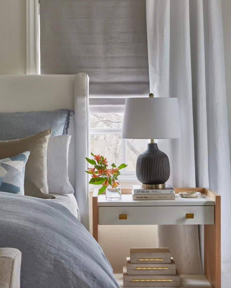 Wood-Framed White Nightstand with Ribbed Black Lamp and Bright Orange Florals