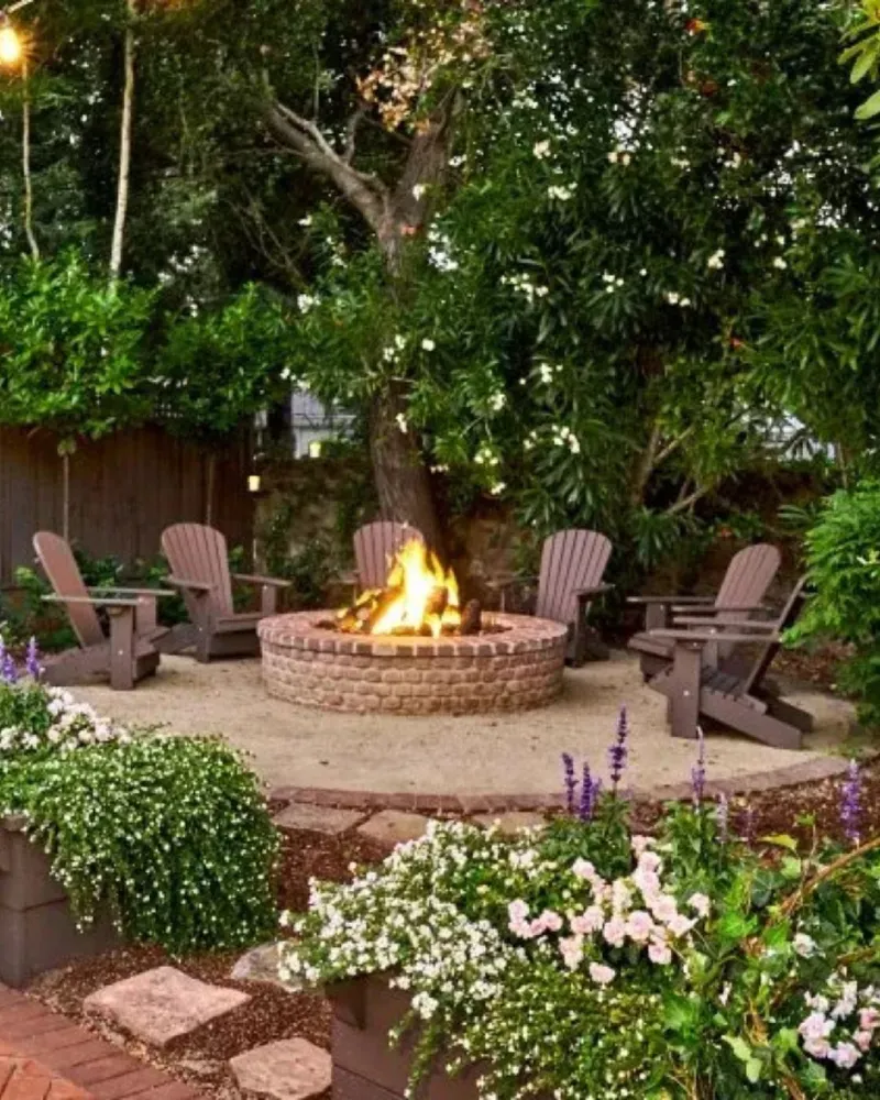  Woodland Fire Pit Circle Framed by Flower Beds and Mature Shade Trees
