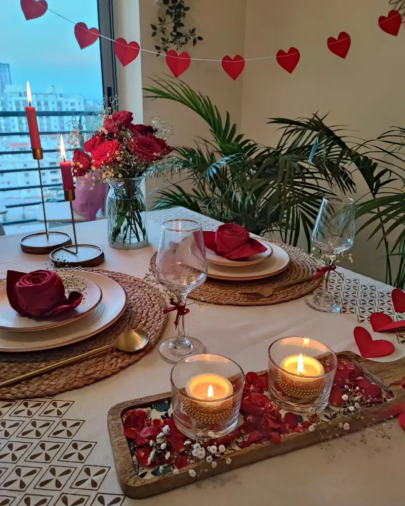 Woven Rattan Placemats with Rose-Folded Napkins and Glass Candle Tray