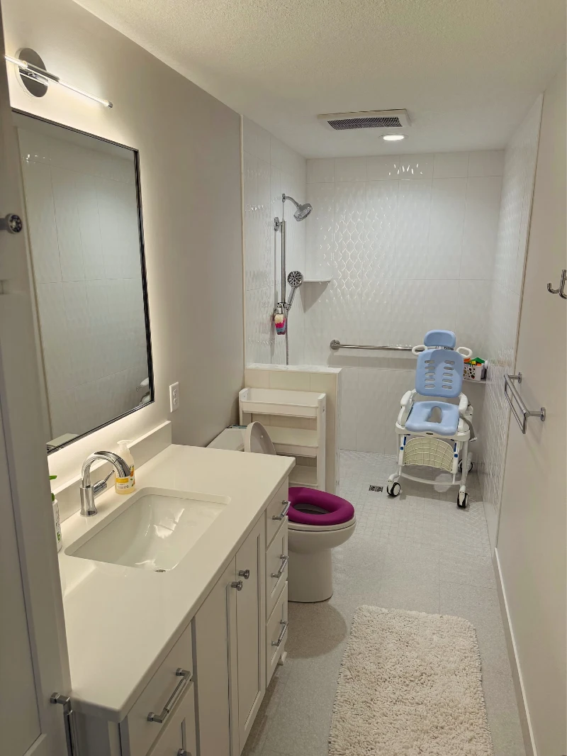 Accessible Barrier-Free Wet Room with Padded Shower Chair and Floating Vanity