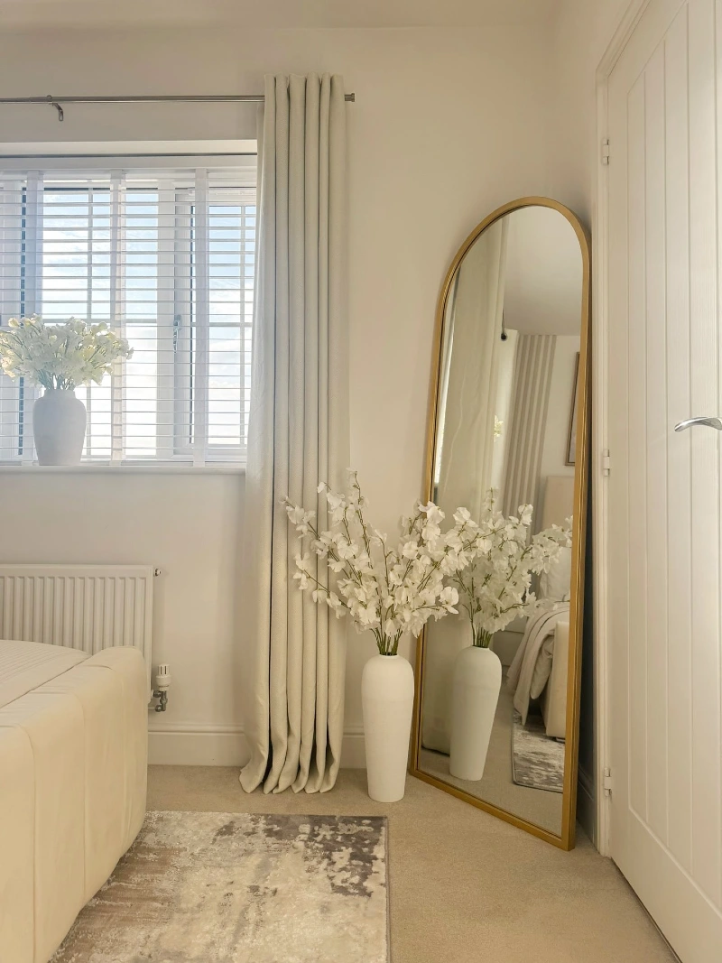 Arched Brass Floor Mirror with White Blossom Vase