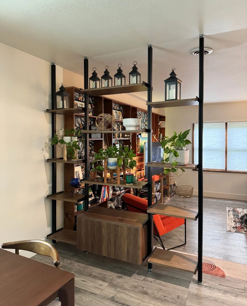 Black Steel Frame Partition with Trailing Pothos and Lanterns