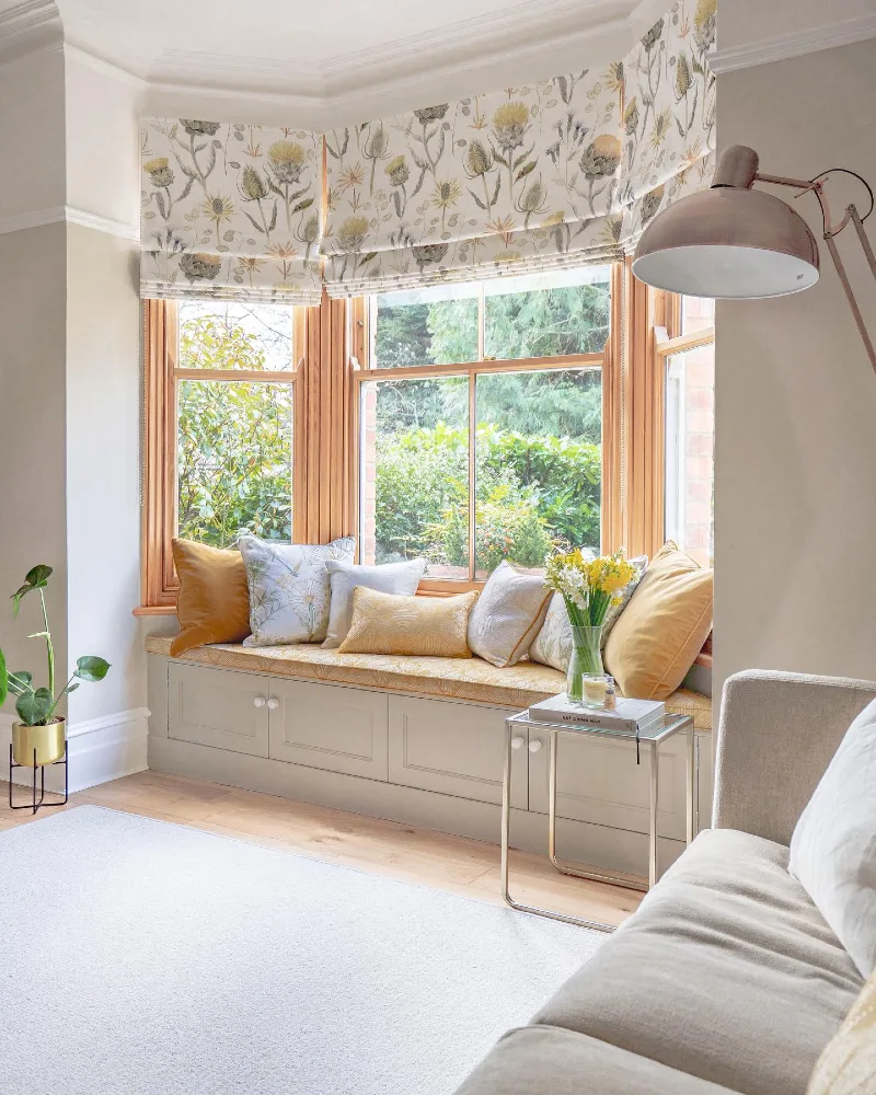 Botanical Roman Shades Wrapped Around a Warm Wood Bay Window