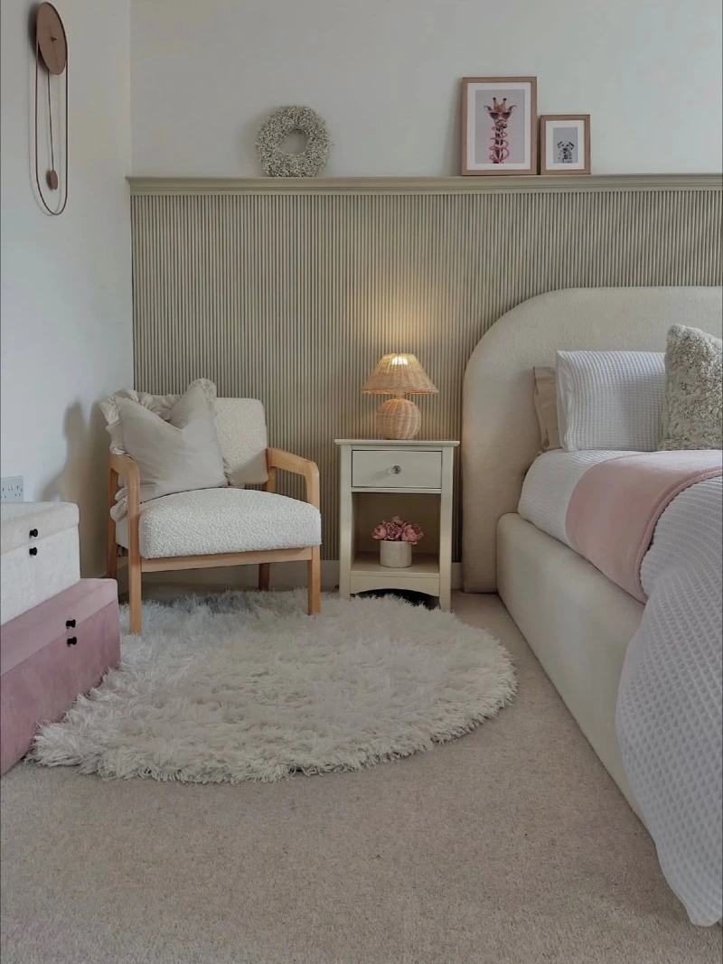 Bouclรฉ Corner Chair with Rattan Lamp and Fluted Wall Panel