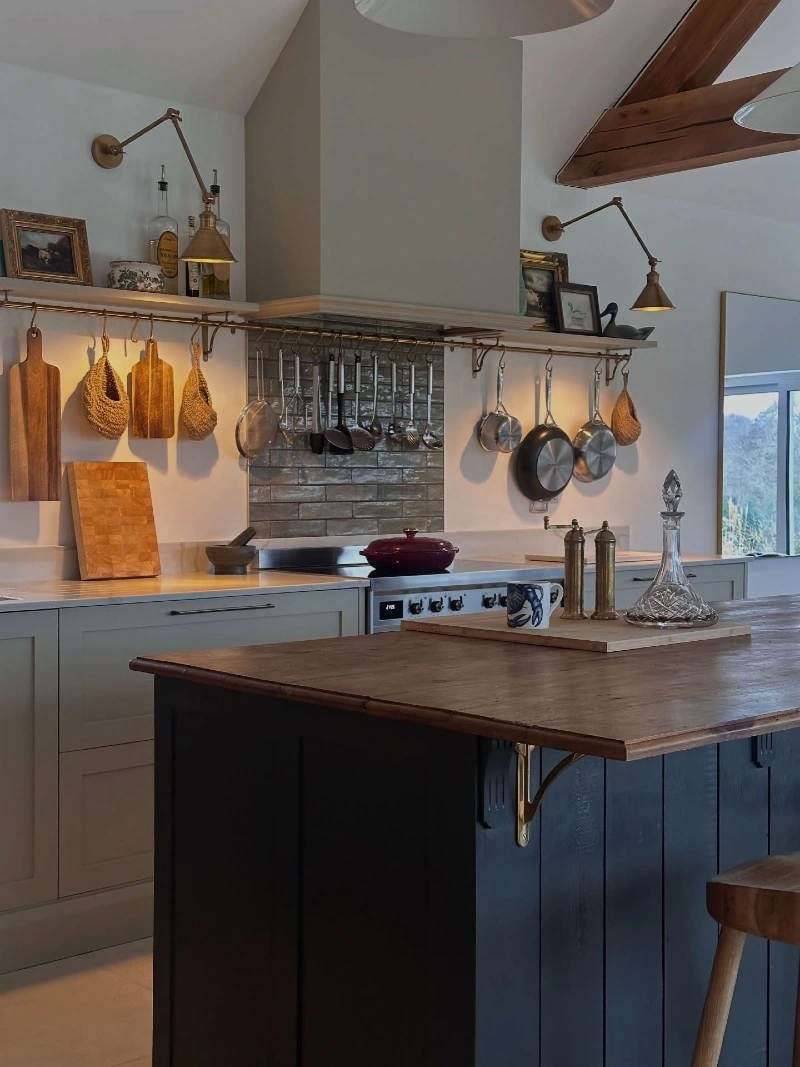 Brass Rail Shelf with Hanging Copper Pans and Oversized Wood Boards