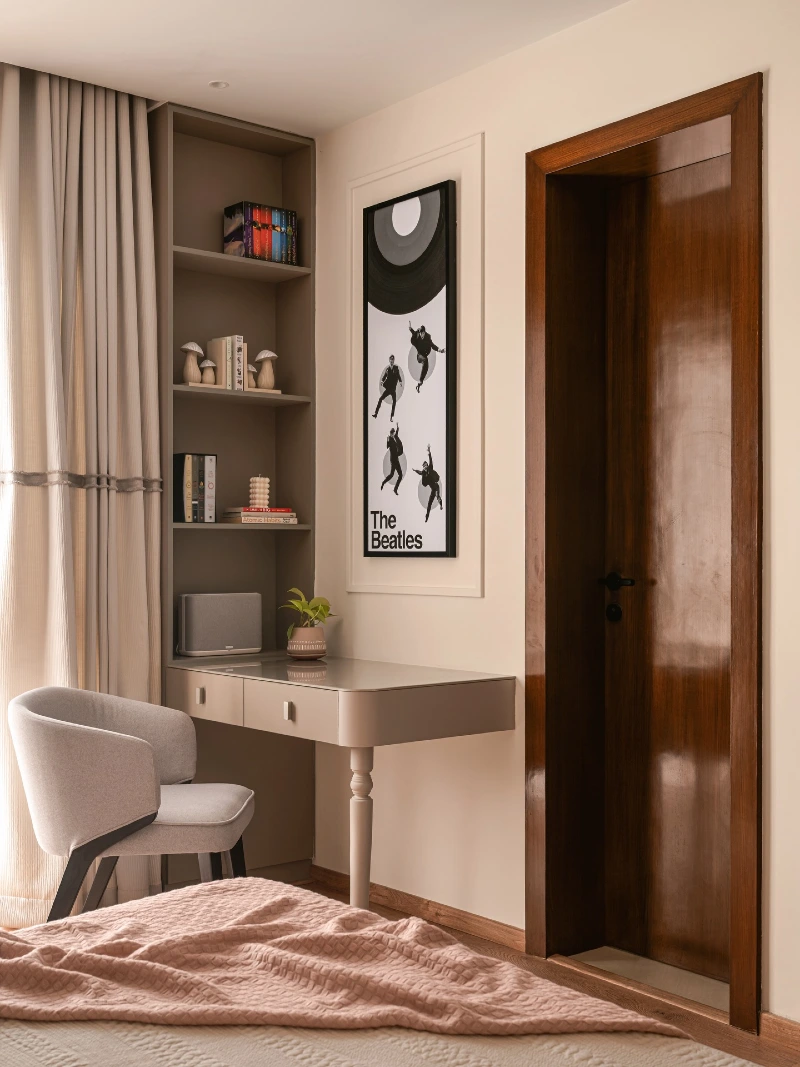 Built In Corner Desk with Tall Bookshelves and Upholstered Chair