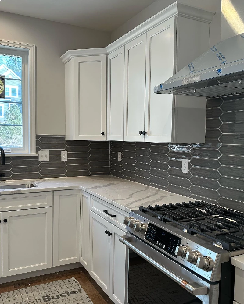 Charcoal Elongated Hex Tile with White Shaker Cabinets