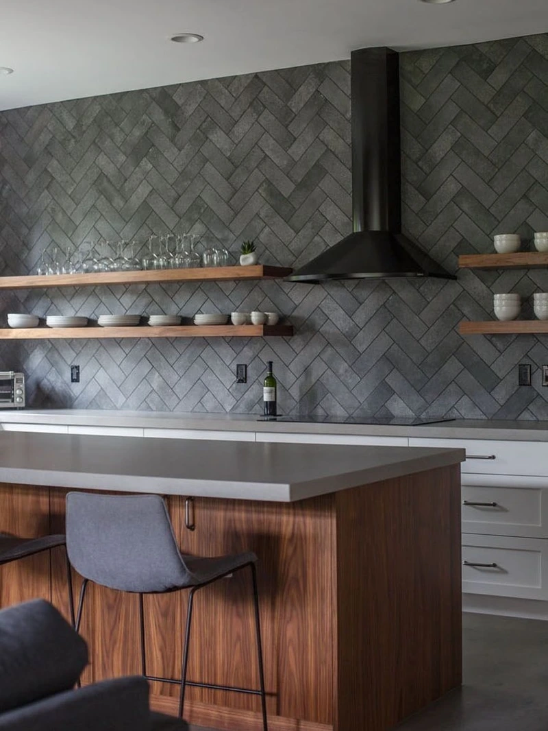 Charcoal Herringbone Wall Tile with Floating Walnut Shelves and Matte Black Hood