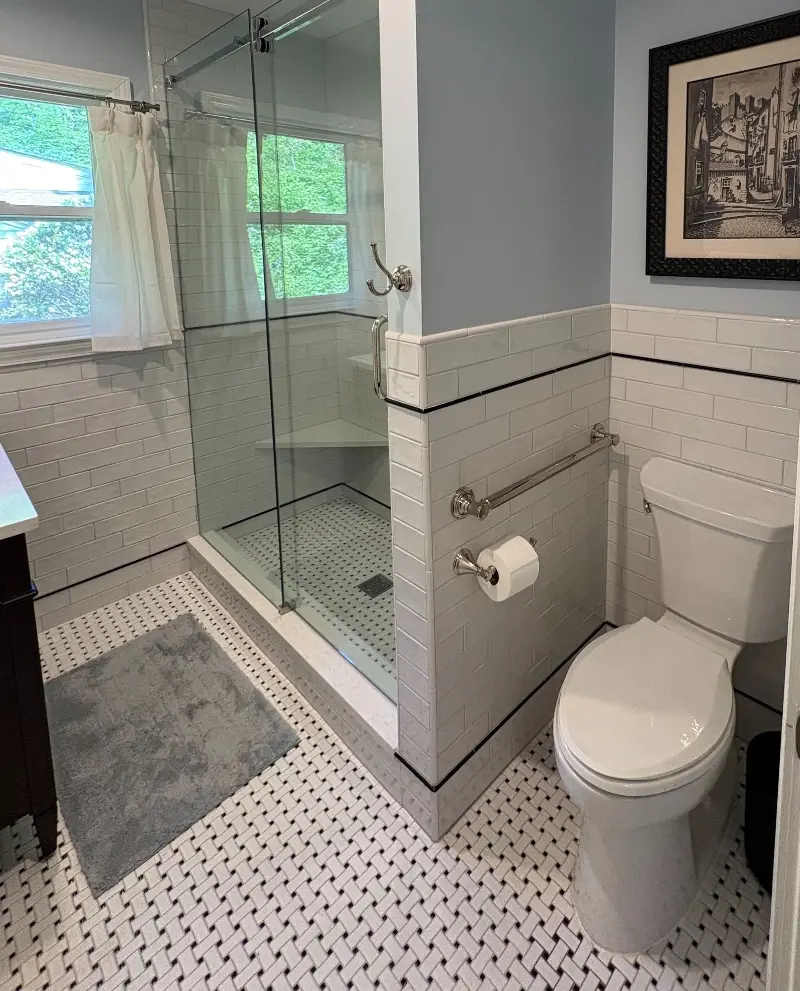 Classic White Subway Tile Bathroom with Basketweave Floor and Glass Shower Door
