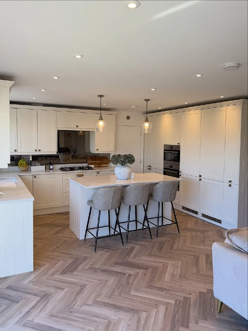 Compact White Island with Upholstered Stools and Slim Breakfast Bar