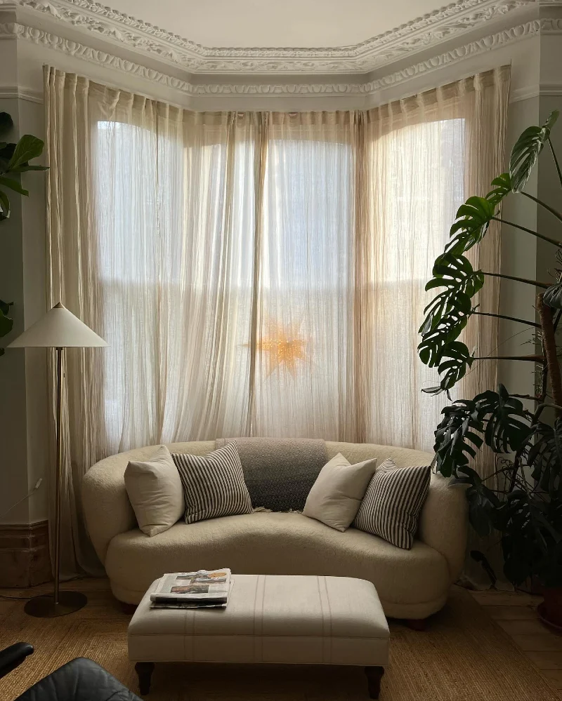 Floor Length Sheer Curtains Wrapped Around a Curved Bay Window