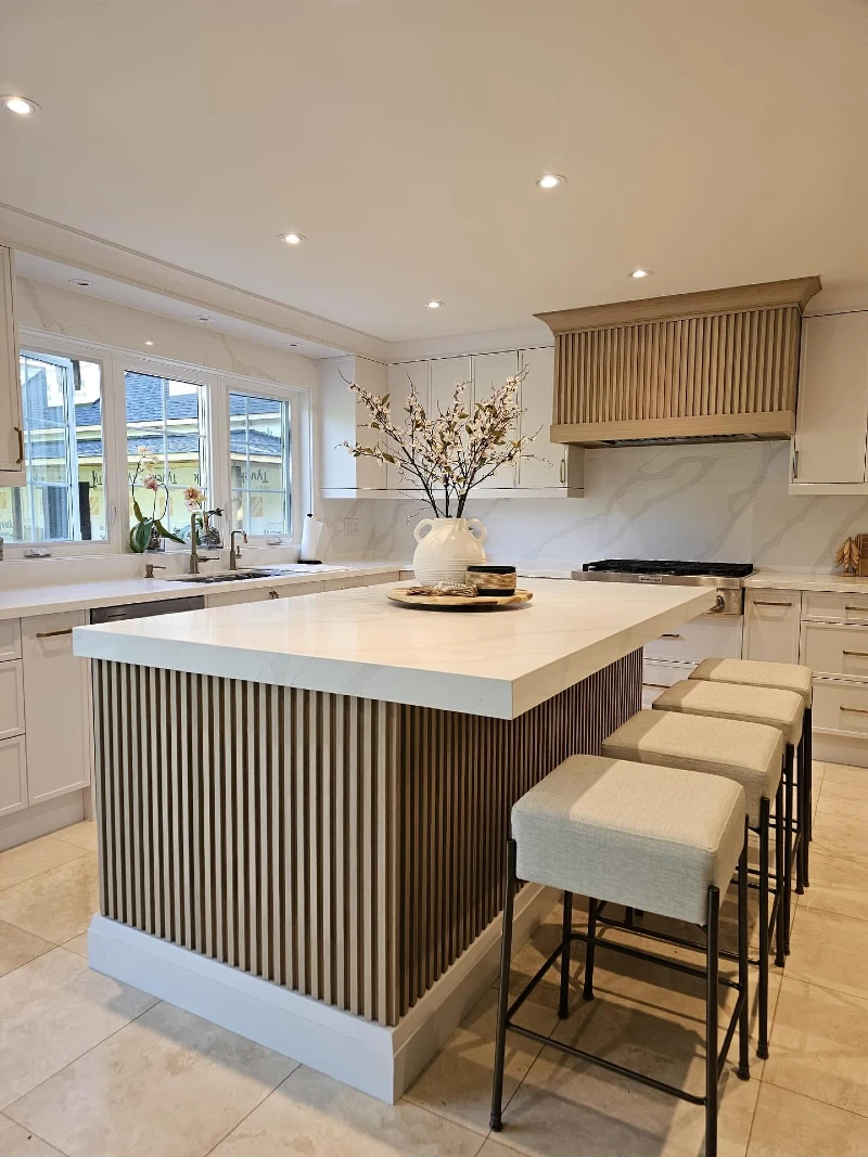 Fluted Wood Island with Thick White Counter and Four Upholstered Stools