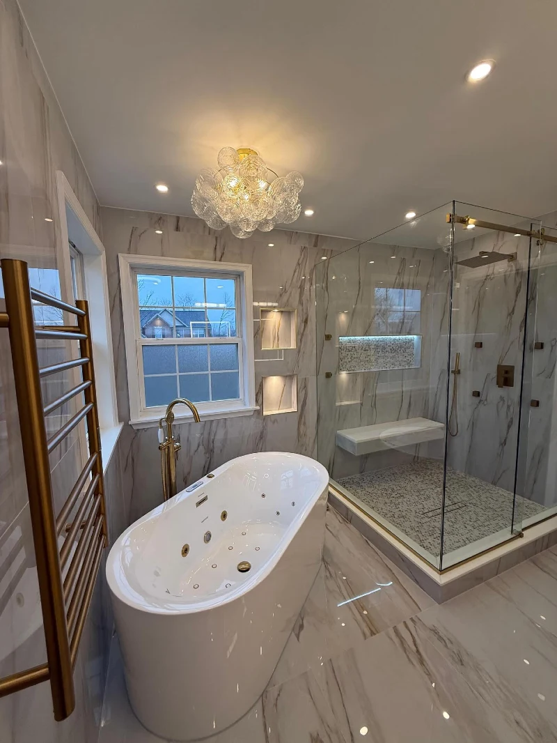 Freestanding Whirlpool Tub with Brushed Gold Bubble Chandelier and Heated Towel Rail