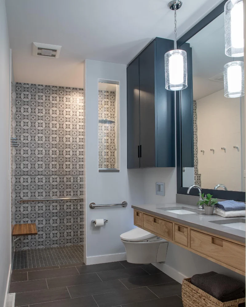 Geometric Patterned Shower Tile with Floating Wood Vanity and Wall-Mounted Toilet