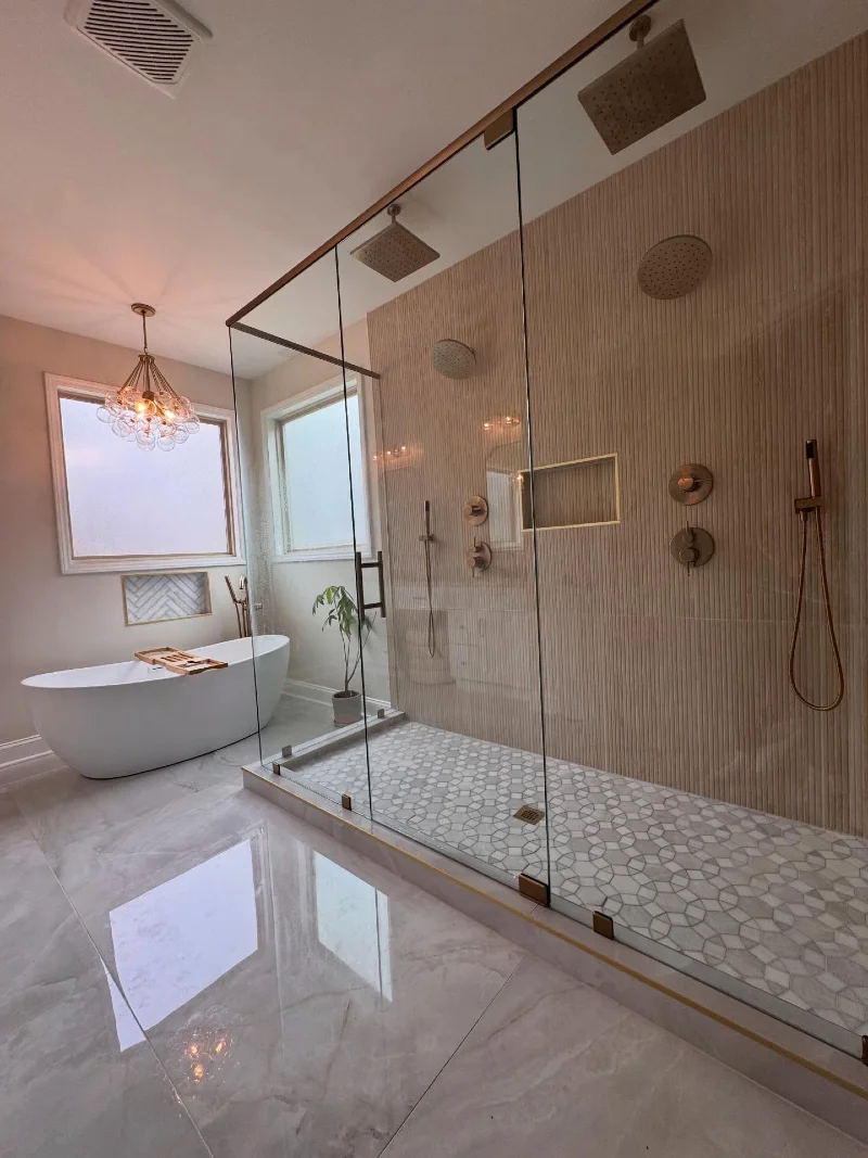 Glass Walk-in Shower with Geometric Mosaic Floor and Dual Showerheads