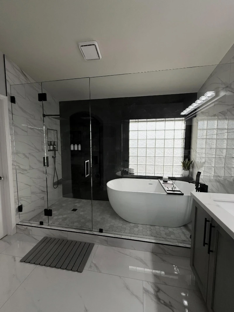 Glass Wet Room Enclosure with Monochrome Marble and Glass Block Window