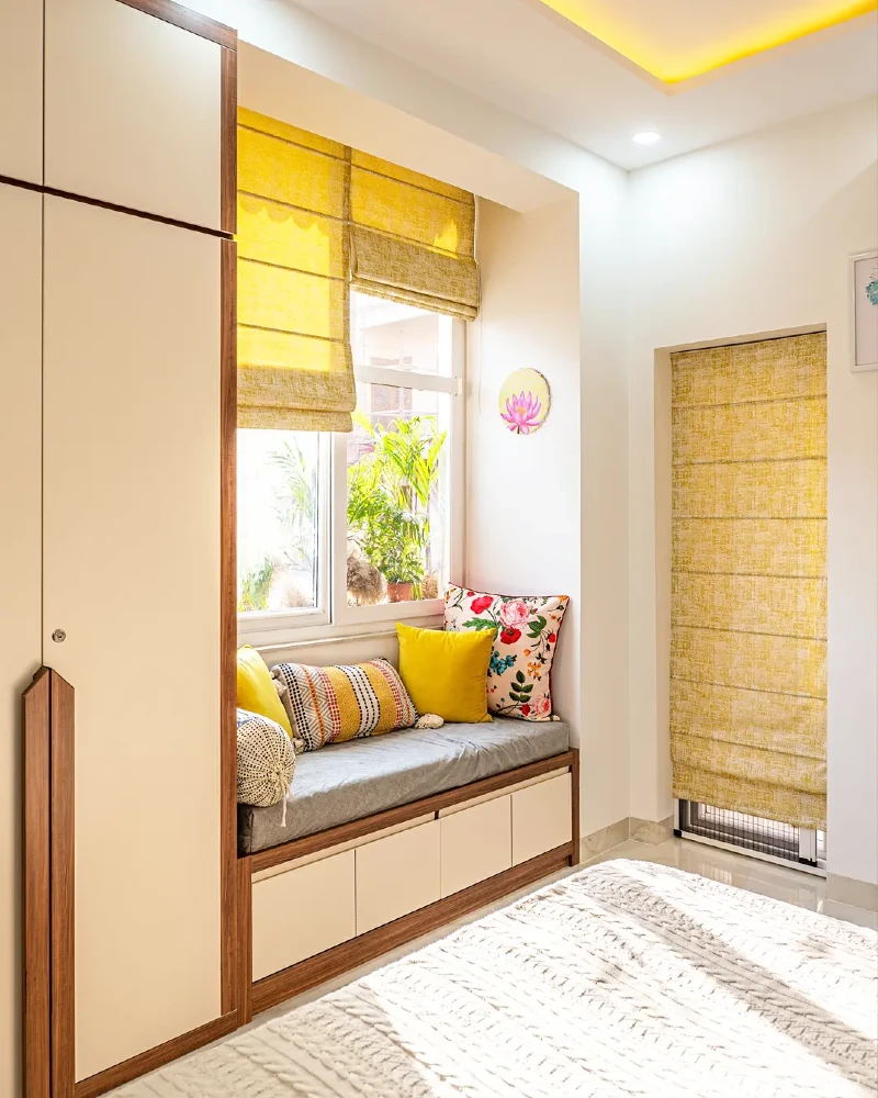 Golden Woven Roman Shades Framing a Compact Window Seat