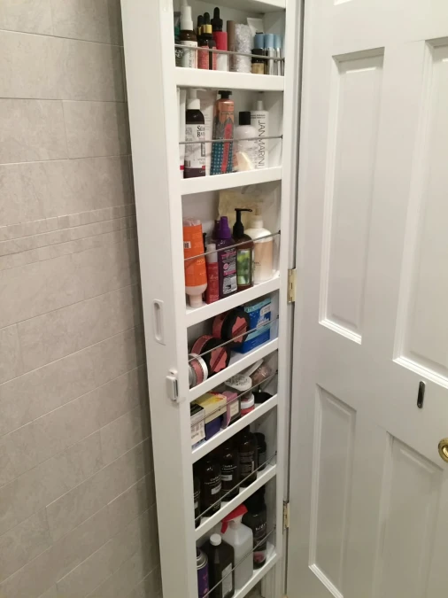 Hinged Door Cabinet Hides Massive Bathroom Storage