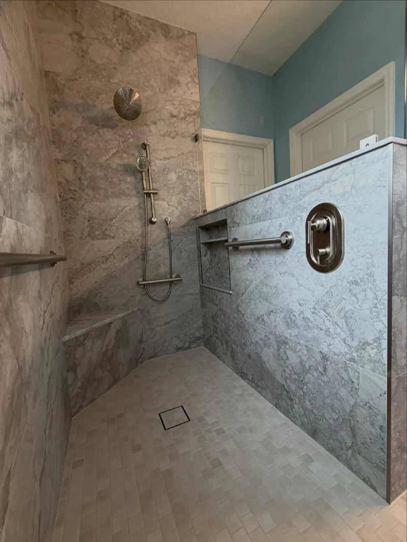Large-Format Marble Tile Walk-In Shower with Low Half-Wall and Brushed Nickel Controls