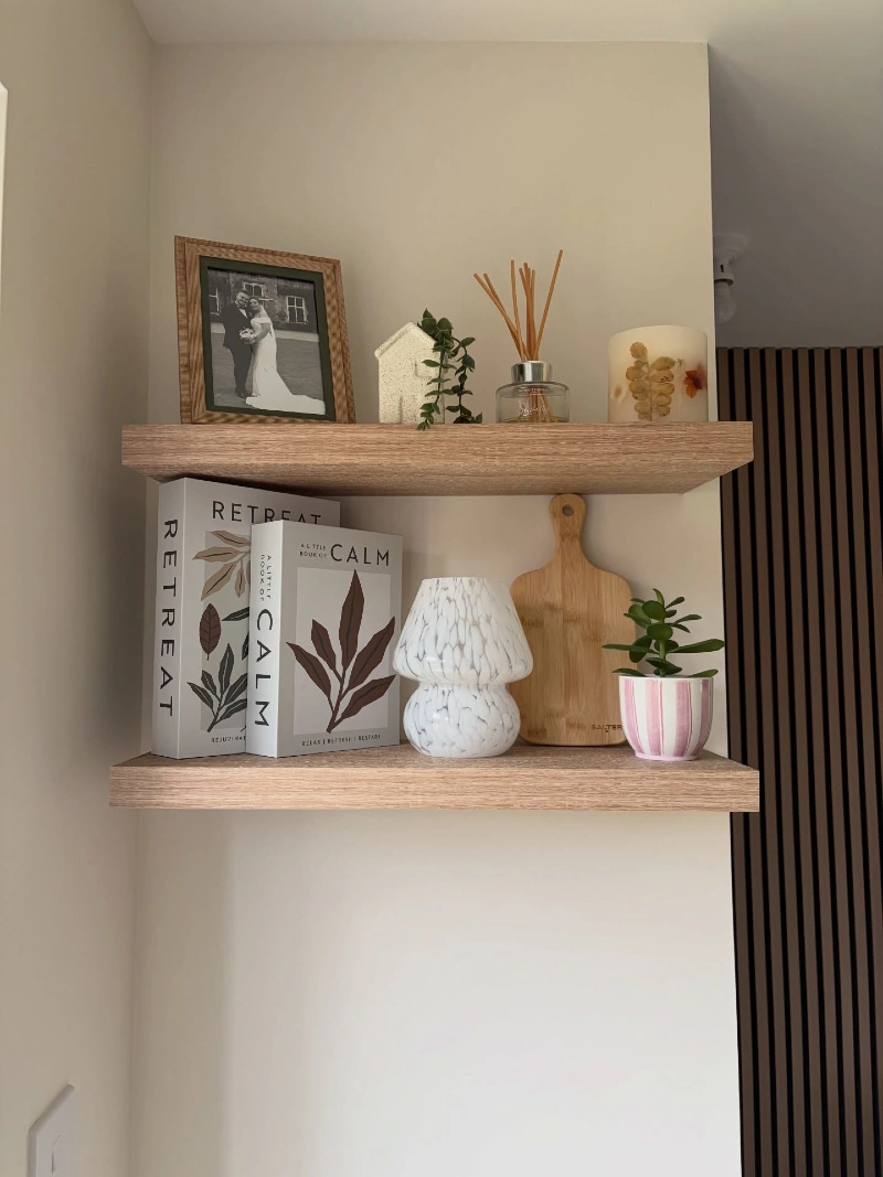 Light Oak Floating Shelves with Books, Framed Photo, and Soft Ceramic Accents