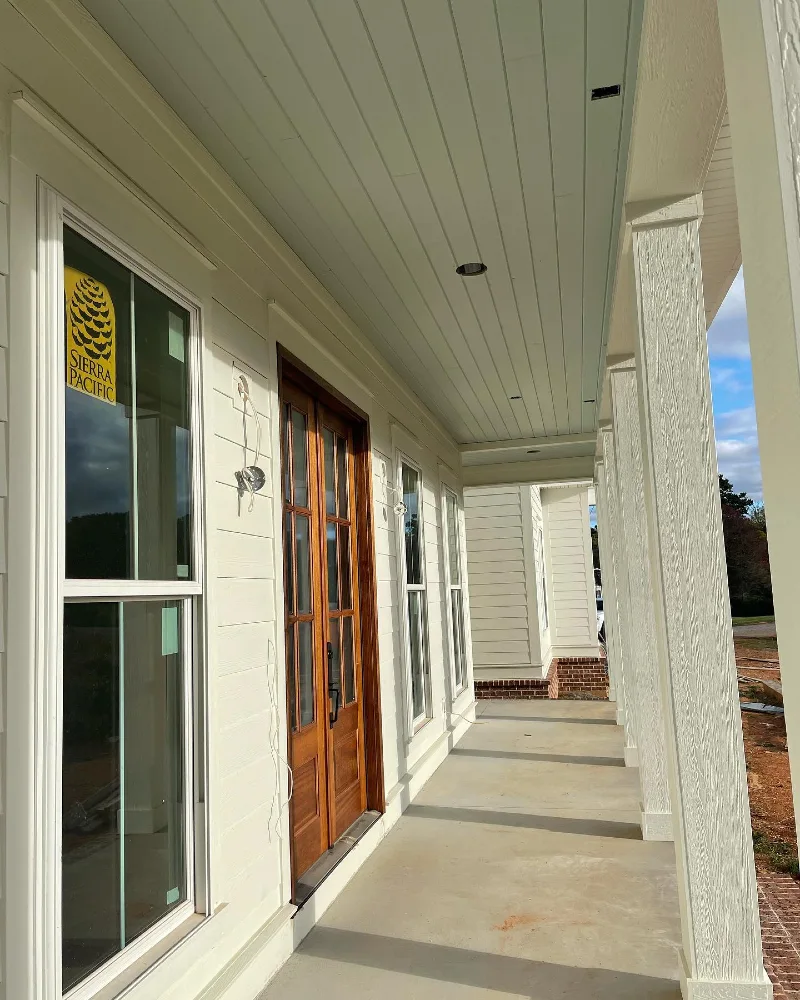 Long Covered Front Porch with Pale Blue V-Groove Planks