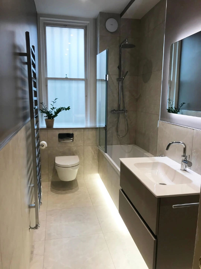 Modern Taupe Tile Bathroom with Floating Vanity and Integrated Toe-Kick Lighting