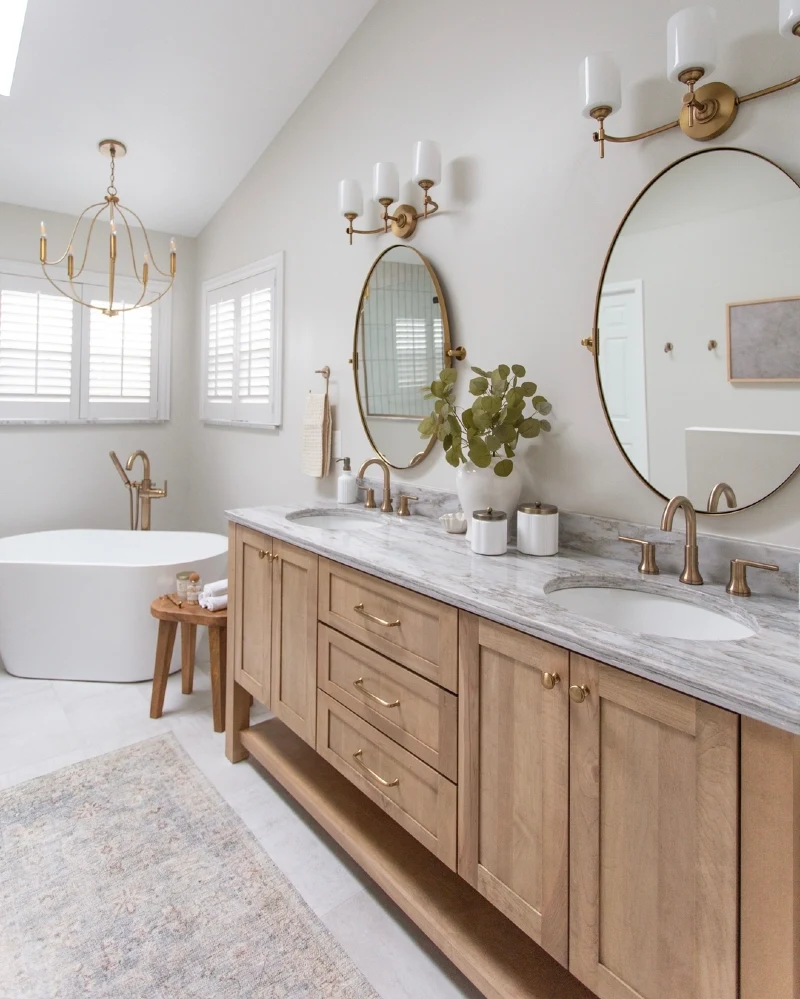 Natural Oak Double Vanity with Oval Mirrors and Brass Chandelier