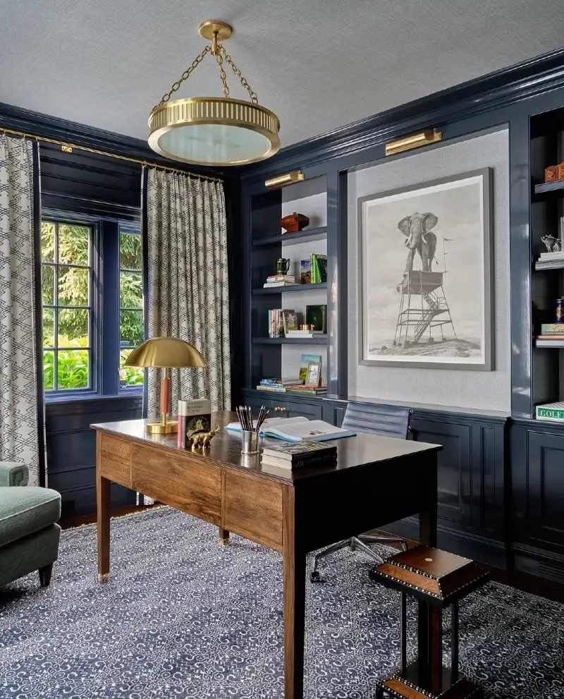 Navy Paneled Library with Brass Lamps and Warm Wood Desk