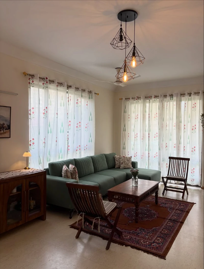 Olive Green Channel-Tufted Sectional with Persian Rug and Geometric Caged Pendants
