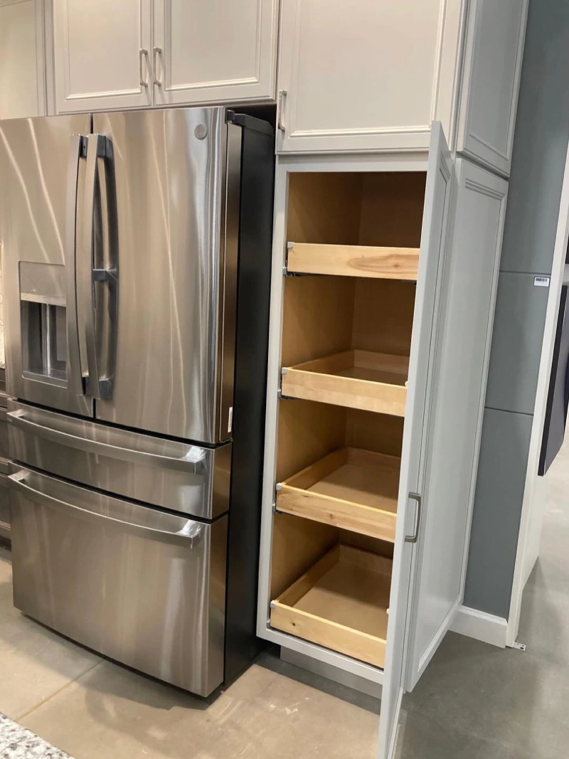 Pull-Out Wooden Pantry Trays Beside Stainless Steel Refrigerator