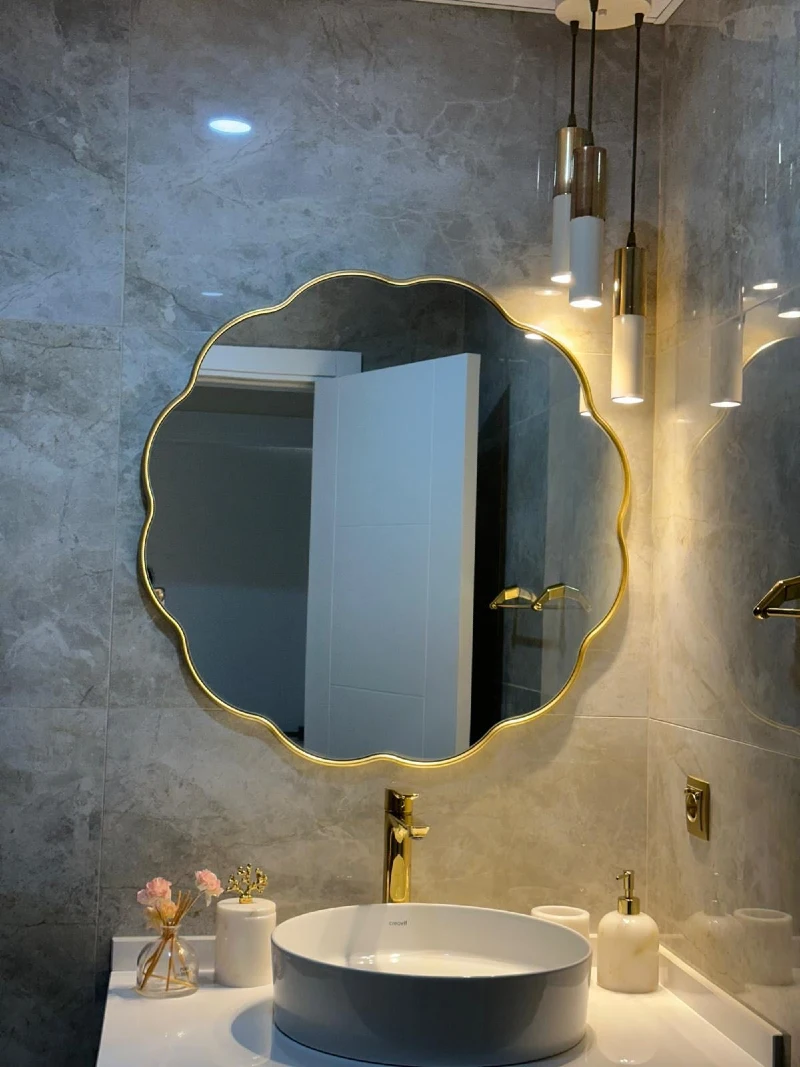 Scalloped Circular Brass Mirror on Grey Marble Tile