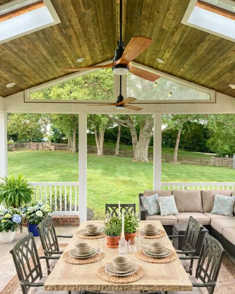 Vaulted Olive-Stained Wood Ceiling with Dual Ceiling Fans and Skylights