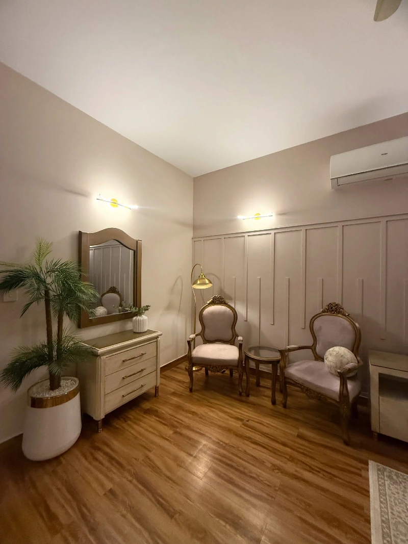 Vintage Accent Chairs with Round Side Table and Tall Potted Palm