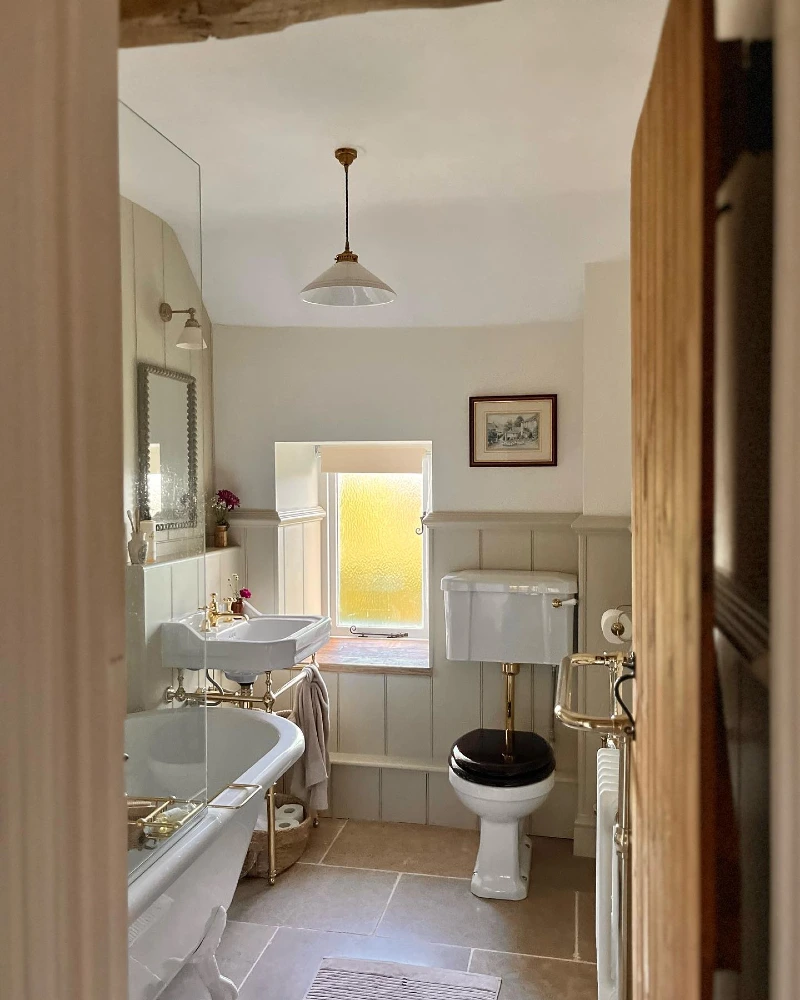 Vintage Cottage Bathroom with Brass Console Sink Stand and Freestanding Soaking Tub