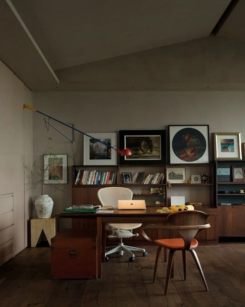 Walnut Desk with Low Bookcases, Framed Art, and Red Task Lamp