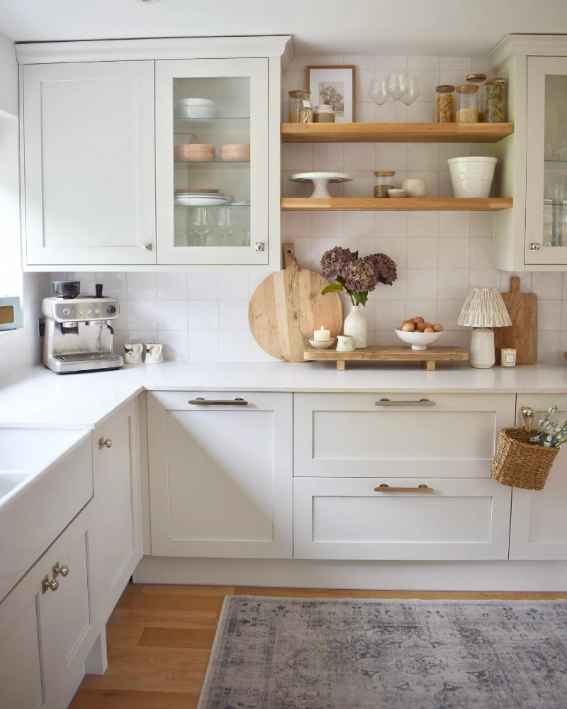 Warm Oak Shelves with Glass Canisters, Soft Ceramics, and Framed Art