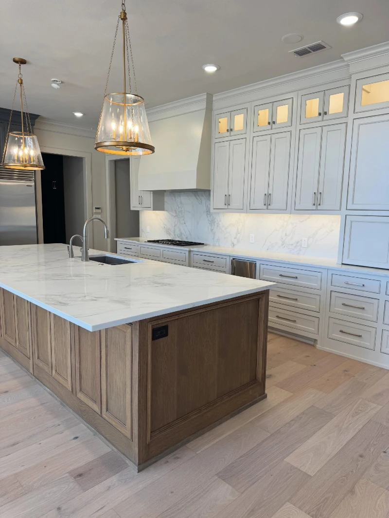 Warm Wood Island with Oversized Stone Top and Integrated Sink
