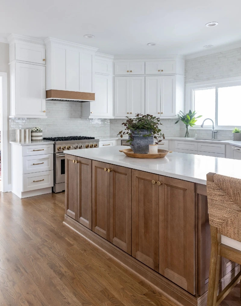 Warm Wood Storage Island with Brass Knobs and White Stone Top