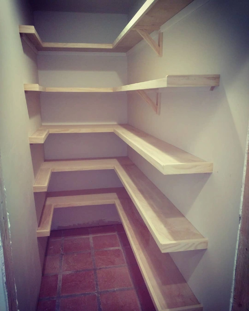 Wrap-Around Raw Wood Pantry Shelves Above Terracotta Tile Floors
